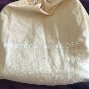 Black cross body purse. Embellishment with silver rivets adjustable strap.